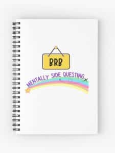 adhd merch: adhd notebook 'brb mentally side questing' rainbow